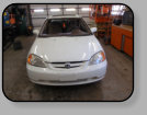 A sorry poor workmanship job on a former replacement windshield installation in a Honda Civic