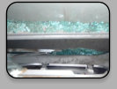Broken tempered glass trapped in the guard beam, and outer door skin