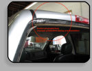 Poor workmanship on a Chevy pickup back glass installation.  The vehicle had to go to an auto body shop to repair the rust and holes that were cut into the pinchweld.